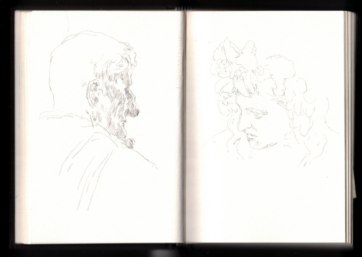On the left, a male head seen from the side, almost from behind. He has short hair and a big nose. We can't really see his traits and he has a piece of clothes down his shoulder. On the right, a male head looking down, wearing a grape and vine crown.