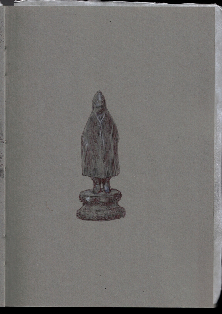 A small statue of a human wearing a hooded cloak which covers almost all their body save the feet and the face. It has its own small round stand. The impression is of someone small and isolated but maybe not absolutely in the sad way, like some bystander in the rain maybe. It has been sketched using black ball pen, black and white gouache on a grey paper sketchbook.